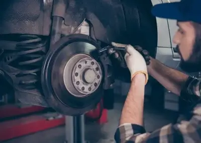 Automotive Technician Adjusting Brakes
